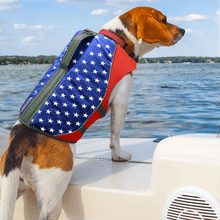 Load image into Gallery viewer, Dog on a boat wearing an american flag patterned life preserver vest
