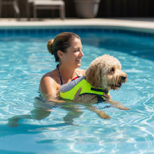 Load image into Gallery viewer, Woman in a pool with a dog wearing a life jacket
