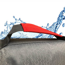 Load image into Gallery viewer, Close up of a red rescue strap on a life preserve vest for dogs against a background with water
